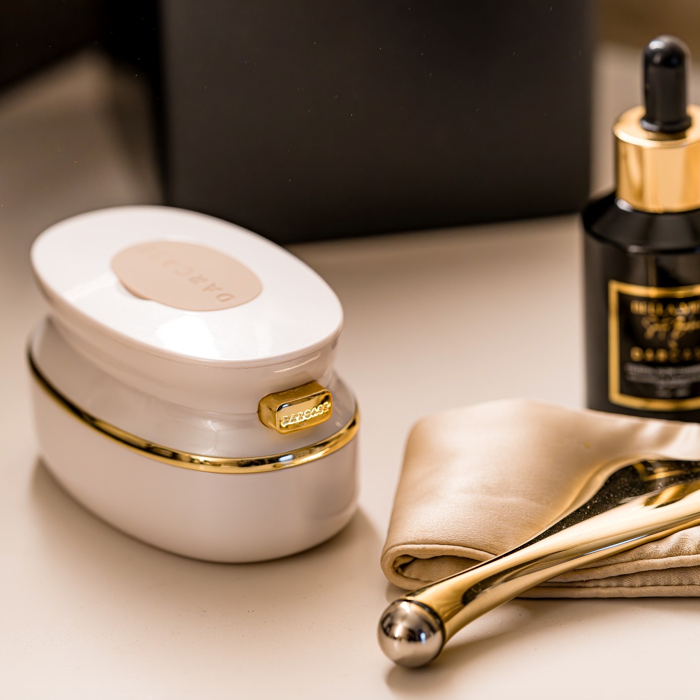 Darcase Ováluxe hairbrush and gold-toned beauty tools on a vanity
